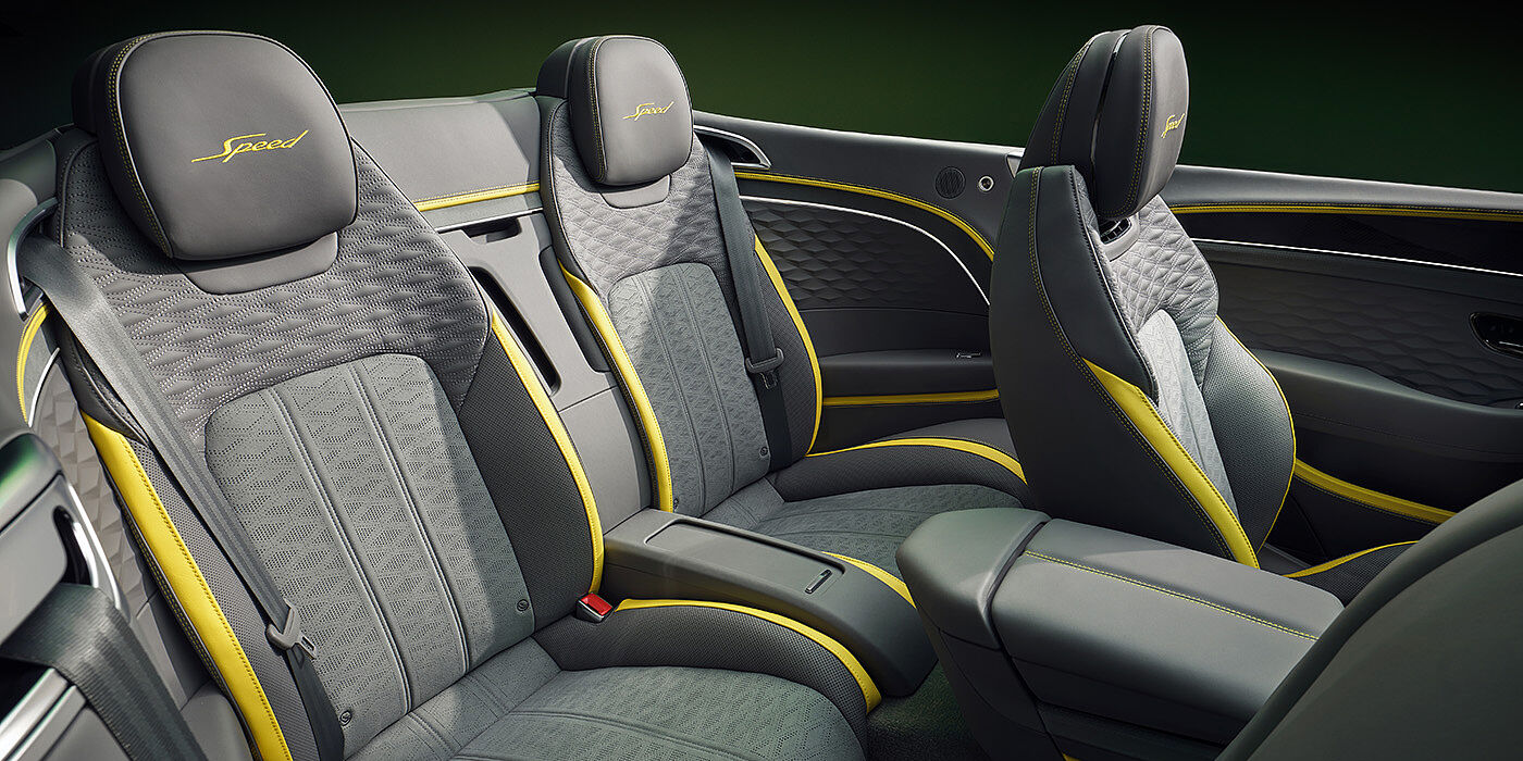 Bentley Budapest Bentley New Continental GTC Speed convertible rear interior with unique Speed colour split in Gravity Grey and Cyber Yellow hide colours, and contrast stitched headrest emblems 