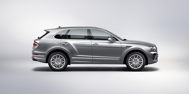 Bentley Budapest Bentley Bentayga SUV side profile in Moonbeam silver paint against white background featuring 21 inch 5 spoke wheels
